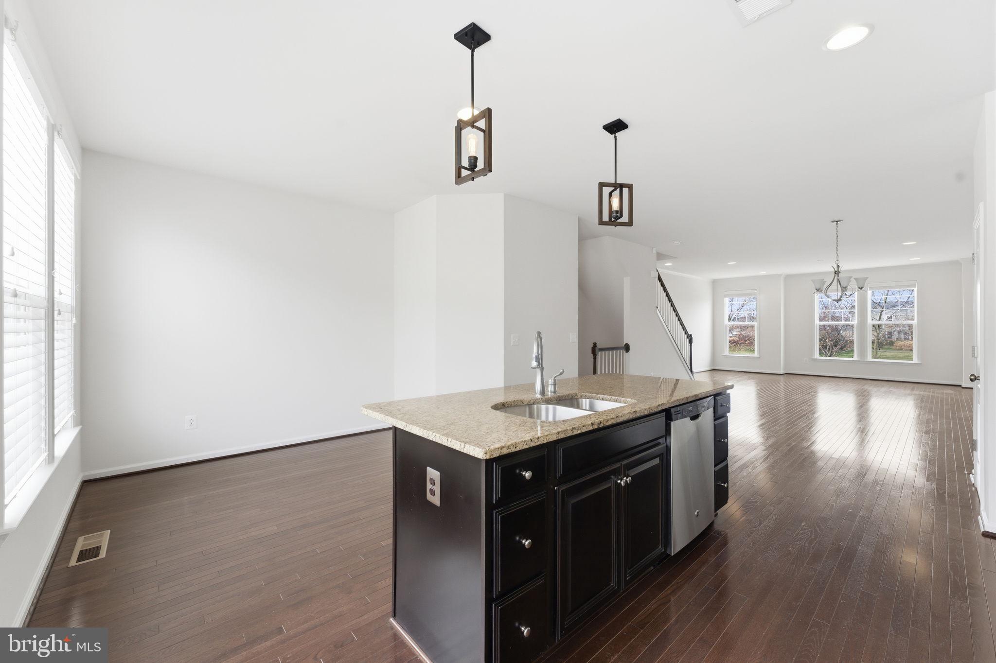 42396 Benfold Square Brambleton, VA 20148 - Photo 64 of 65 a kitchen with a counter space a sink and wooden floor