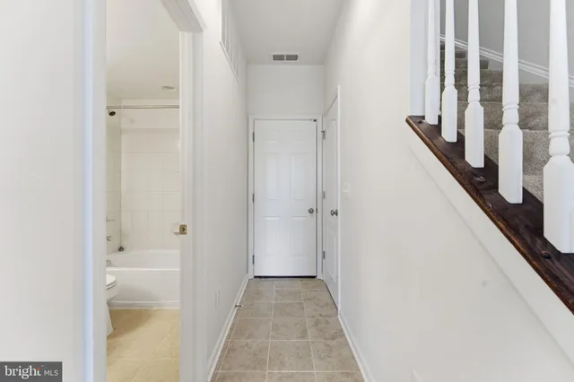 a bathroom with a granite countertop sink a toilet and a bathtub