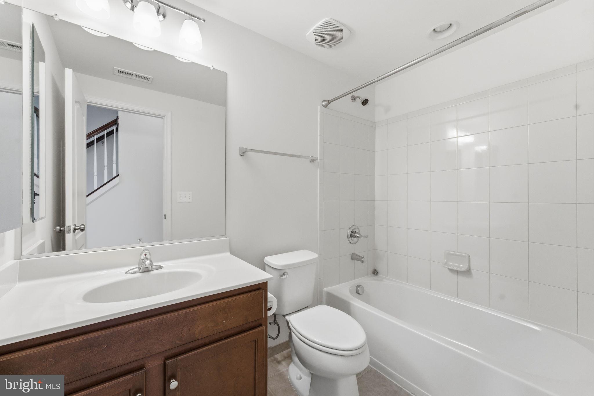 42396 Benfold Square Brambleton, VA 20148 - Photo 8 of 65 a bathroom with a granite countertop sink a toilet and a bathtub