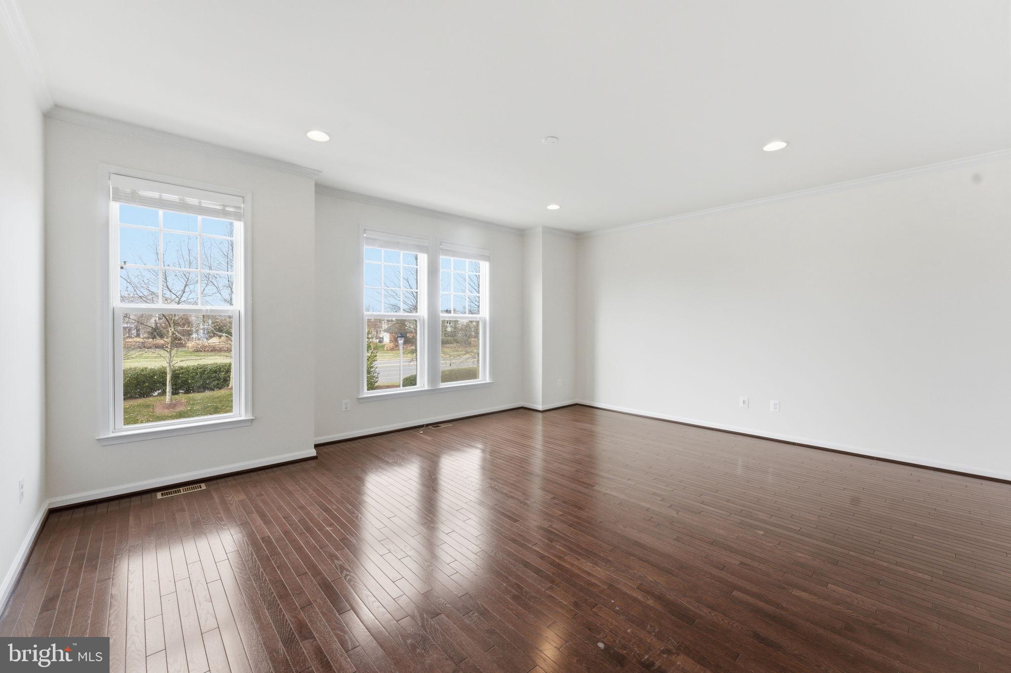 42396 Benfold Square Brambleton, VA 20148 - Photo 10 of 65 an empty room with wooden floor and windows