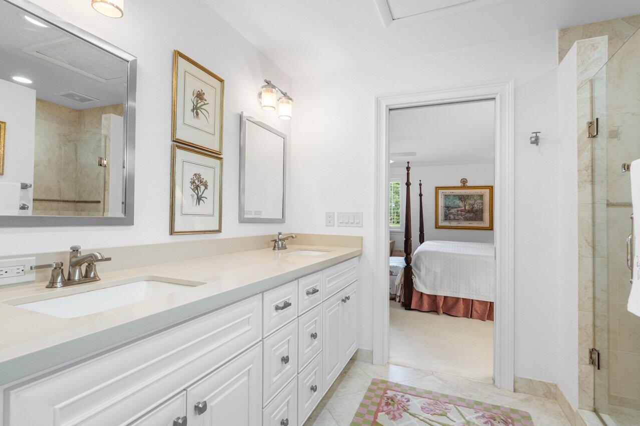 4024 Shelldrake Lane, Unit SHELLDRAKE Boynton Beach, FL 33436 - Photo 34 of 51 a en suite bathroom with 2 sink flowerpot and a mirror