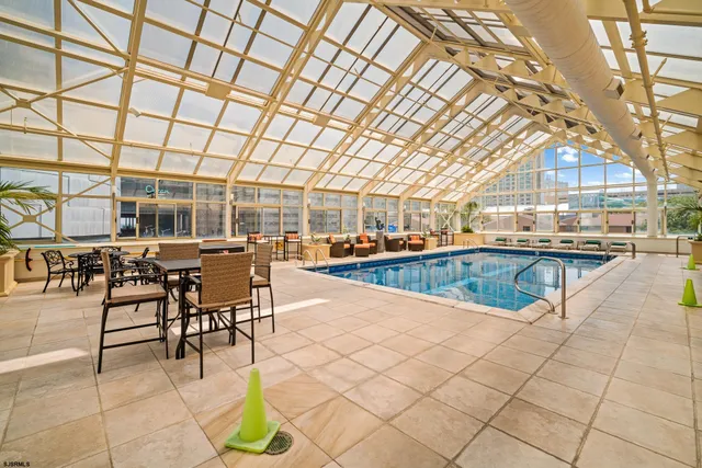 a living room with furniture a dining table and chairs