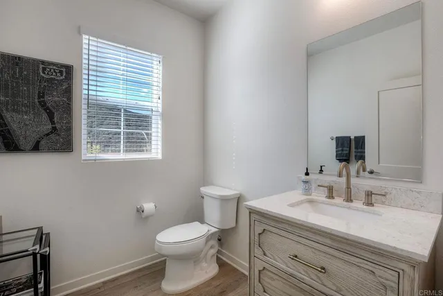 a bathroom with a sink a toilet and a window