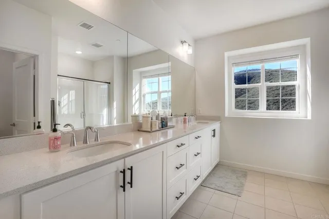 a bathroom with sinks double vanity and a mirror