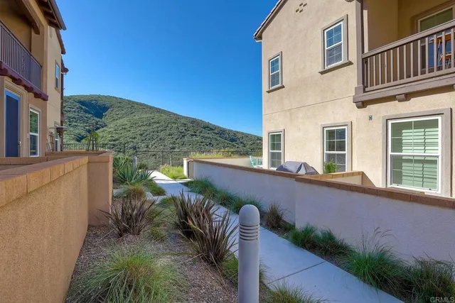 a balcony with furniture and a potted plant