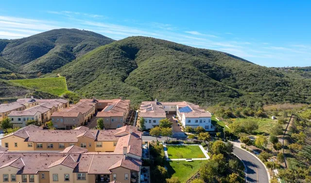 an aerial view of residential houses with outdoor space and river