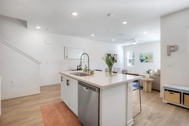 a kitchen with a sink stainless steel appliances and cabinets