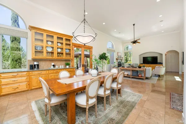 a living room with furniture a fireplace and a chandelier
