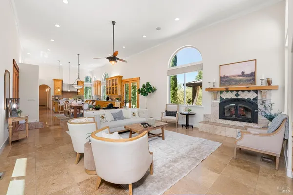 a living room with furniture large window and fireplace