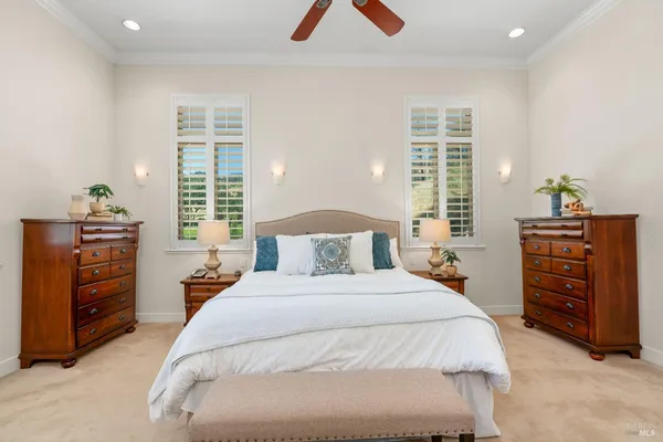a bedroom with a bed furniture and a large window