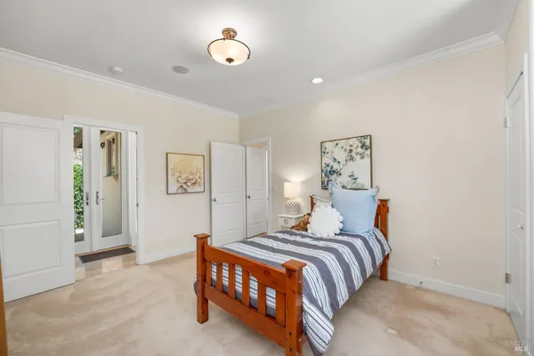 a bed room with a bed and a chair