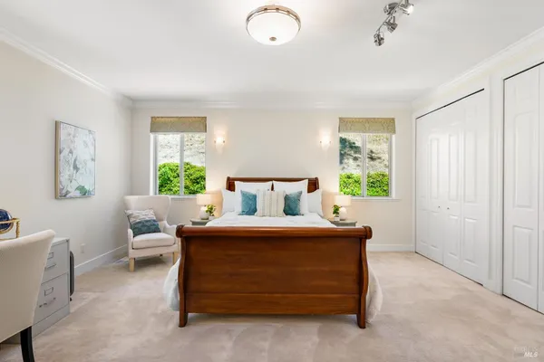 a bedroom with a bed and a large window