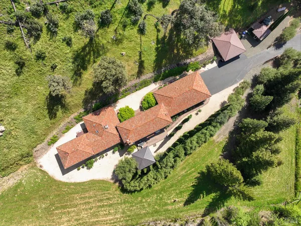 an aerial view of a house with a yard