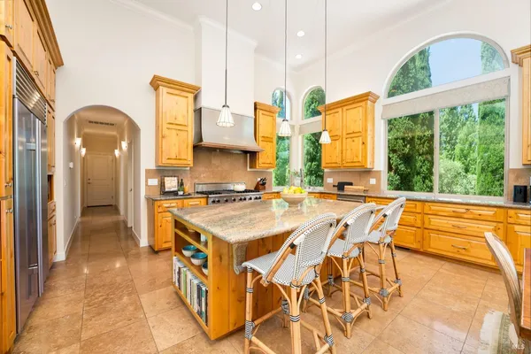 a kitchen with stainless steel appliances granite countertop a stove and a sink