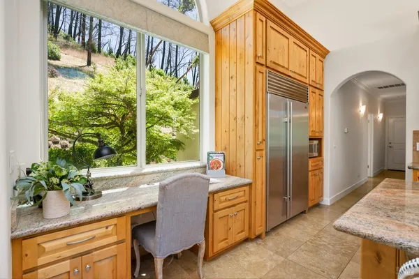 a kitchen with stainless steel appliances granite countertop a sink a counter and cabinets
