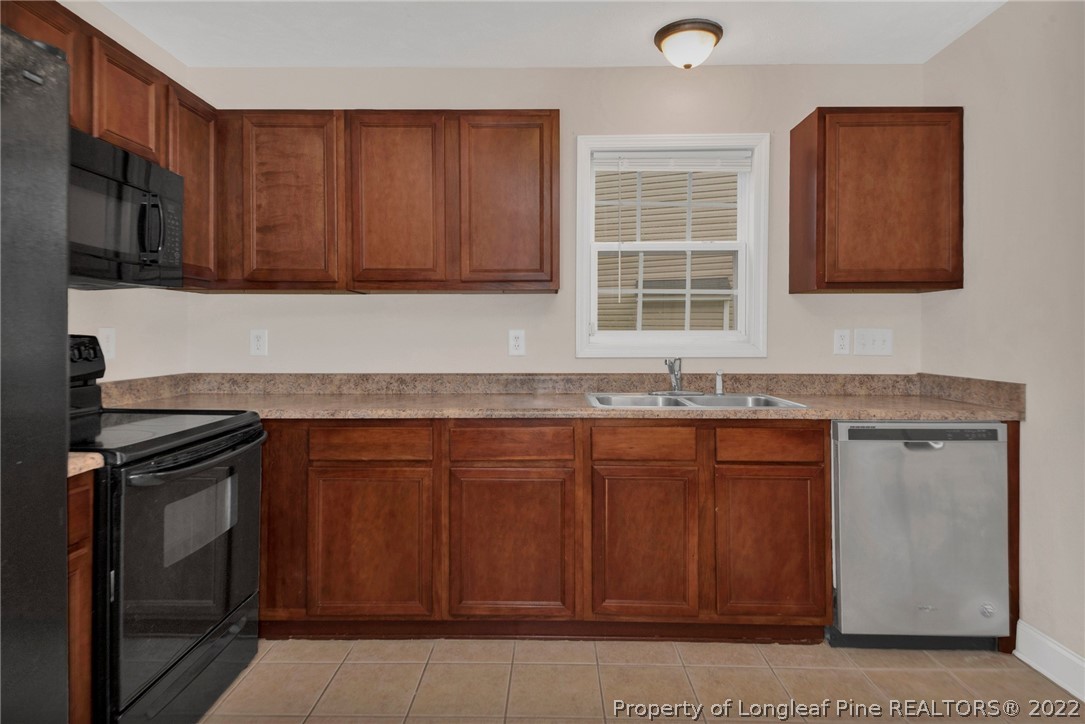 1623 Silver Ridge Court Fayetteville, NC 28304 - Photo 13 of 34 a kitchen with granite countertop stainless steel appliances a stove sink and cabinets
