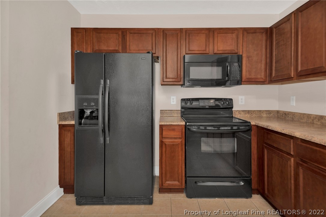 1623 Silver Ridge Court Fayetteville, NC 28304 - Photo 14 of 34 a kitchen with a refrigerator stove and microwave