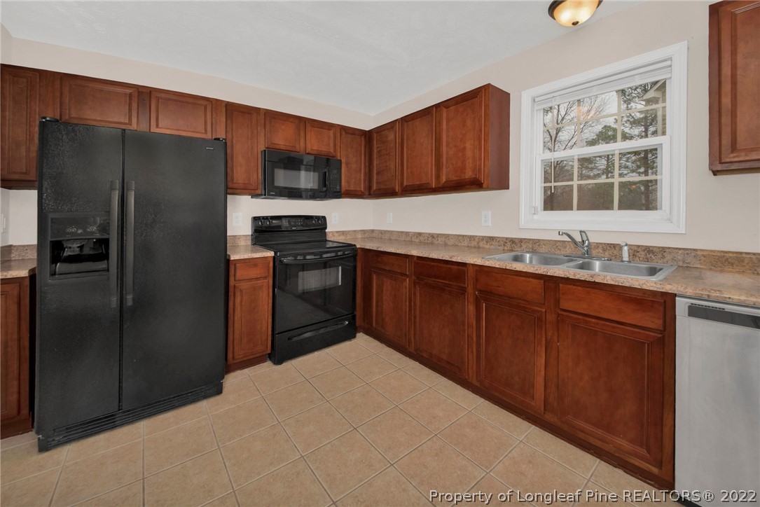 1623 Silver Ridge Court Fayetteville, NC 28304 - Photo 17 of 34 a kitchen with stainless steel appliances granite countertop a refrigerator stove and sink