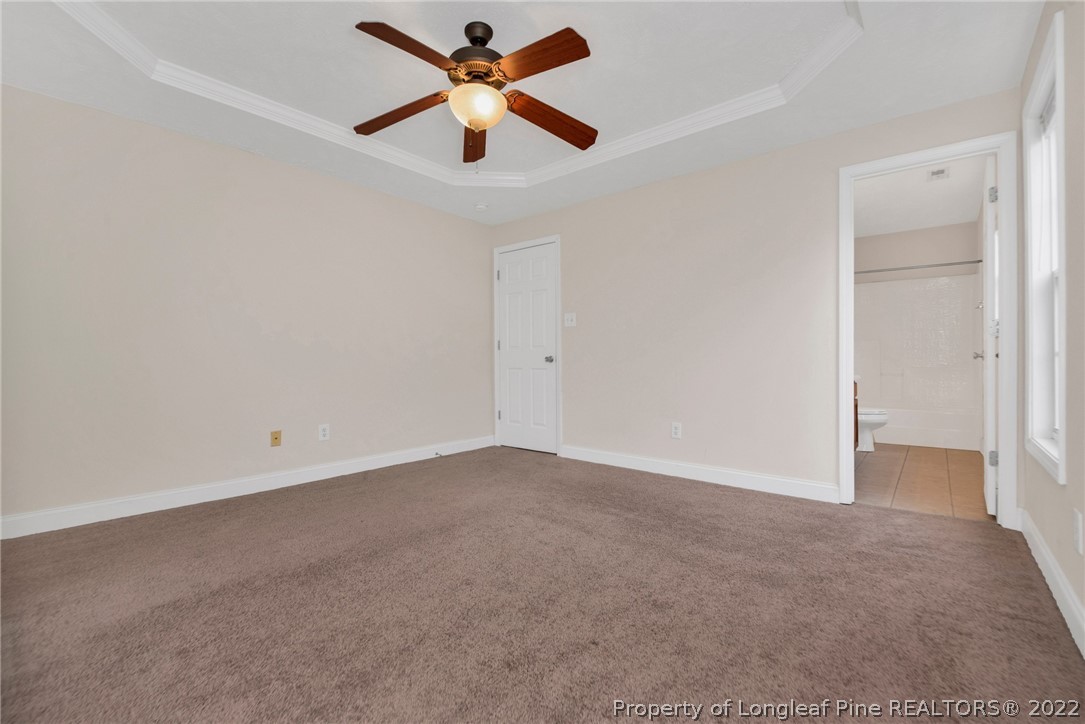 1623 Silver Ridge Court Fayetteville, NC 28304 - Photo 26 of 34 an empty room with a hallway and a ceiling fan
