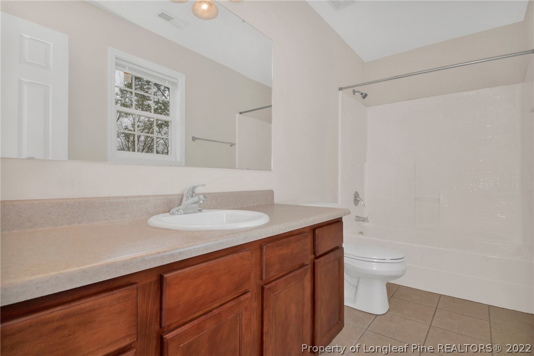 1623 Silver Ridge Court Fayetteville, NC 28304 - Photo 28 of 34 a bathroom with a sink a toilet and shower