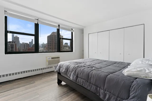 a bedroom with a bed and a window