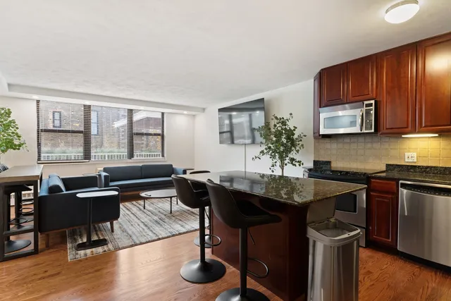 a kitchen with granite countertop sink table and chairs
