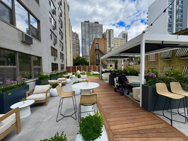 a view of a patio with couches table and chairs potted plants and palm trees