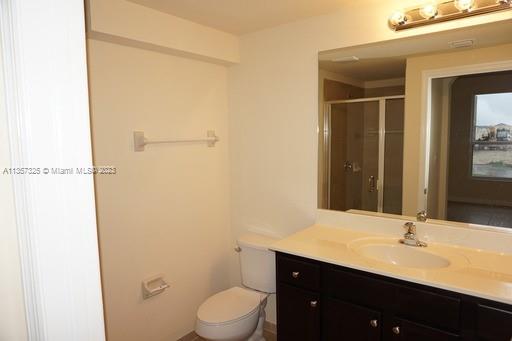 Kendall Commons Miami, FL 33196 - Photo 33 of 37 a bathroom with a toilet a sink and mirror