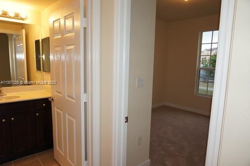 Kendall Commons Miami, FL 33196 - Photo 34 of 37 a bathroom with a mirror a sink and glass door