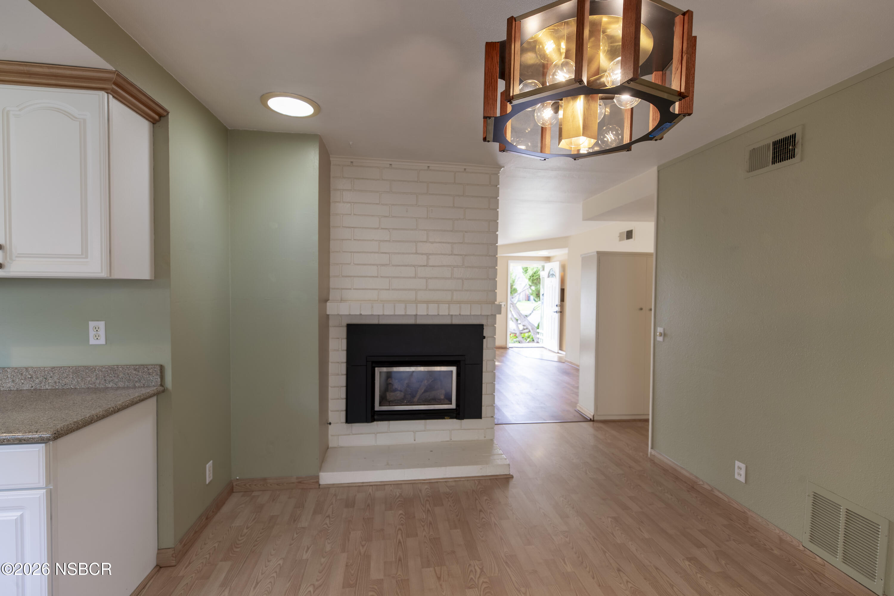124 Princeton Place Lompoc, CA 93436 - Photo 14 of 41 a view of empty room with wooden floor and fireplace