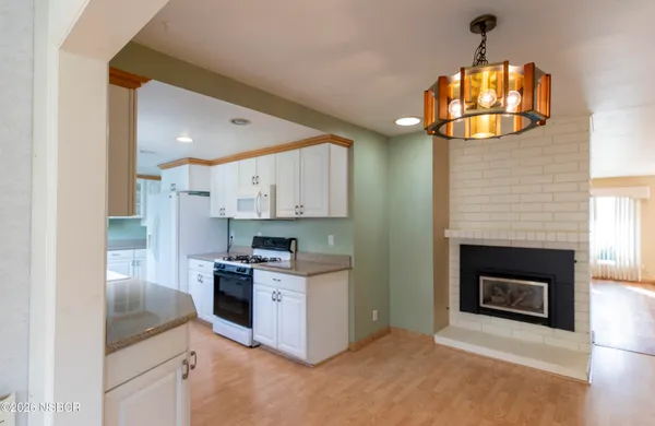a kitchen with a stove and a fireplace