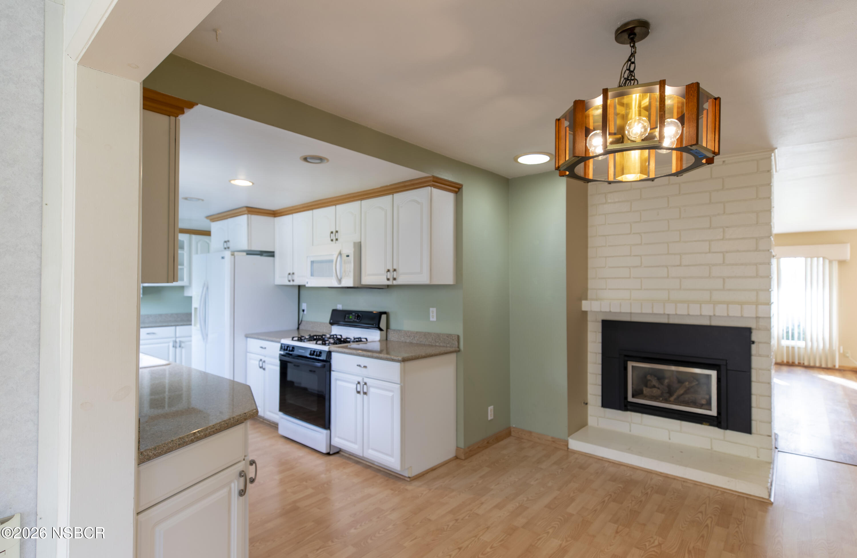 124 Princeton Place Lompoc, CA 93436 - Photo 17 of 41 a kitchen with a stove and a fireplace