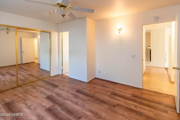 a view of an empty room with wooden floor