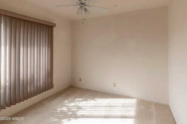a view of a small space with wooden floor and a window