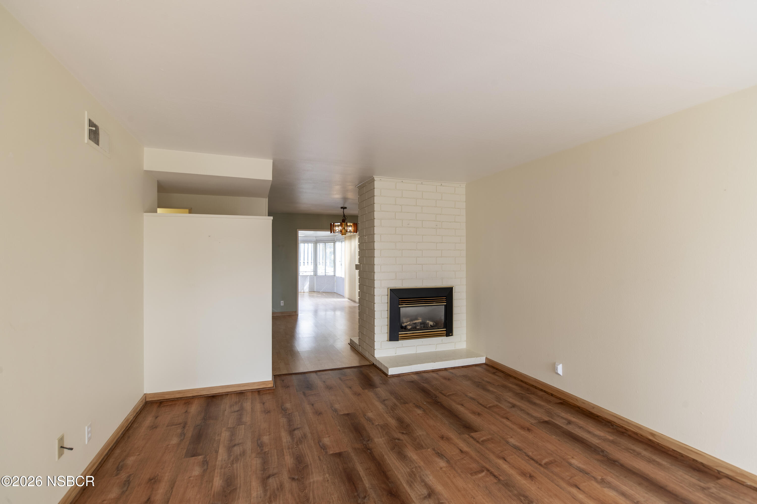 124 Princeton Place Lompoc, CA 93436 - Photo 5 of 41 a view of empty room with wooden floor and a fireplace