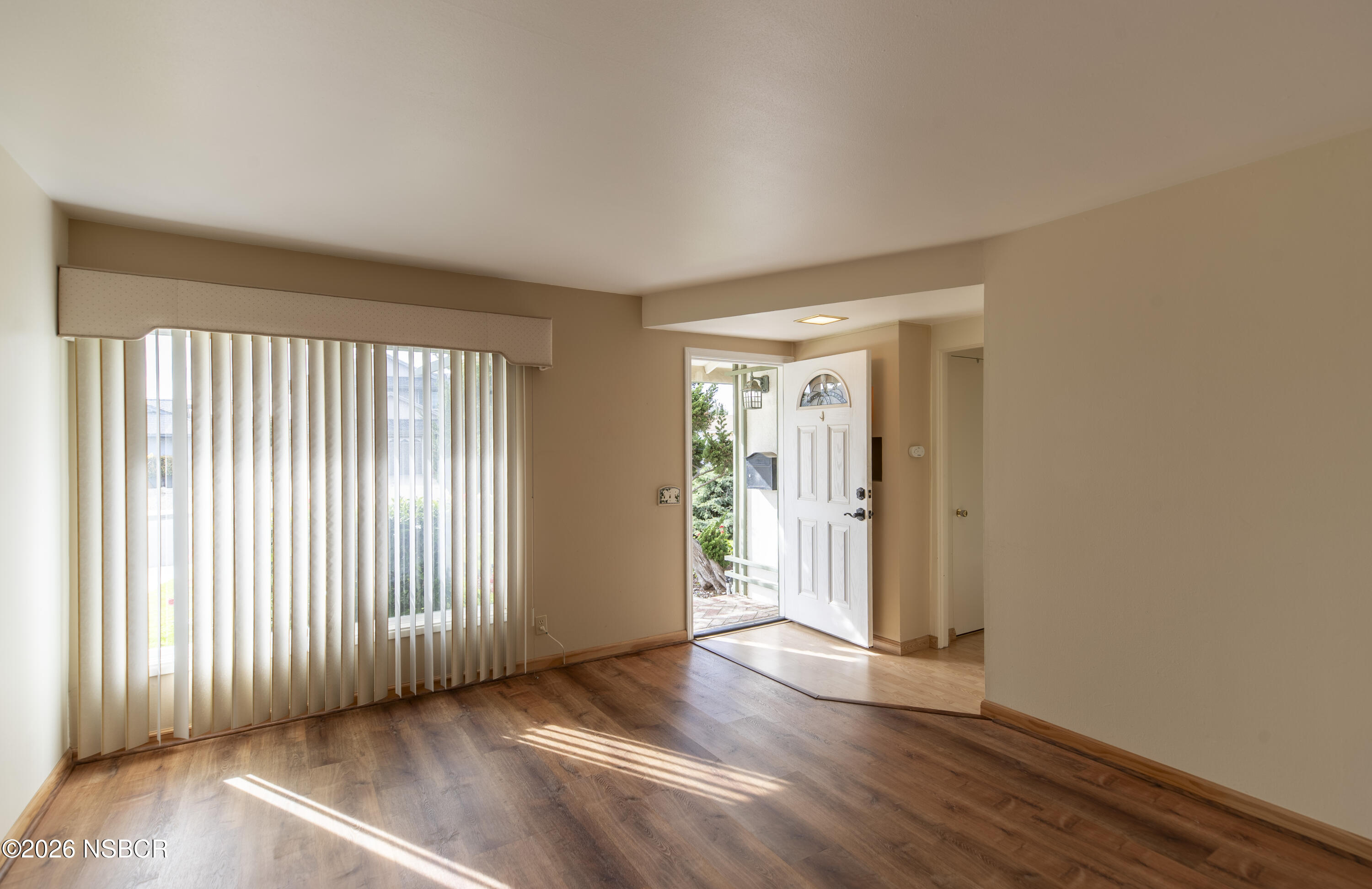 124 Princeton Place Lompoc, CA 93436 - Photo 6 of 41 an empty room with wooden floor and windows