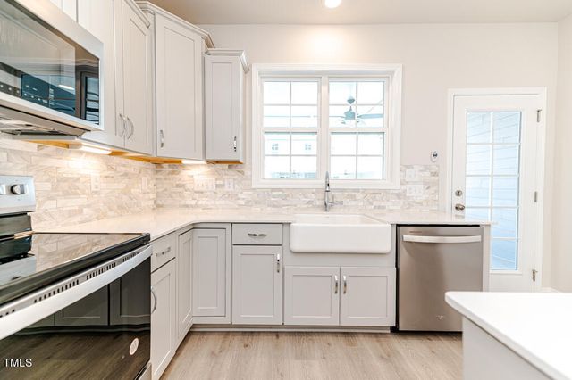 a kitchen with appliances cabinets and a sink
