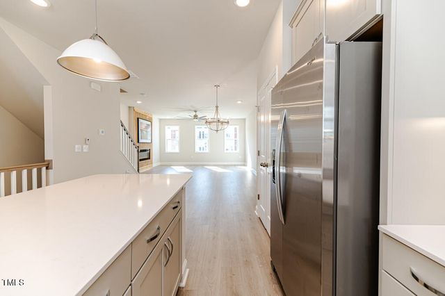 a kitchen with kitchen island a counter top space a sink appliances and cabinets