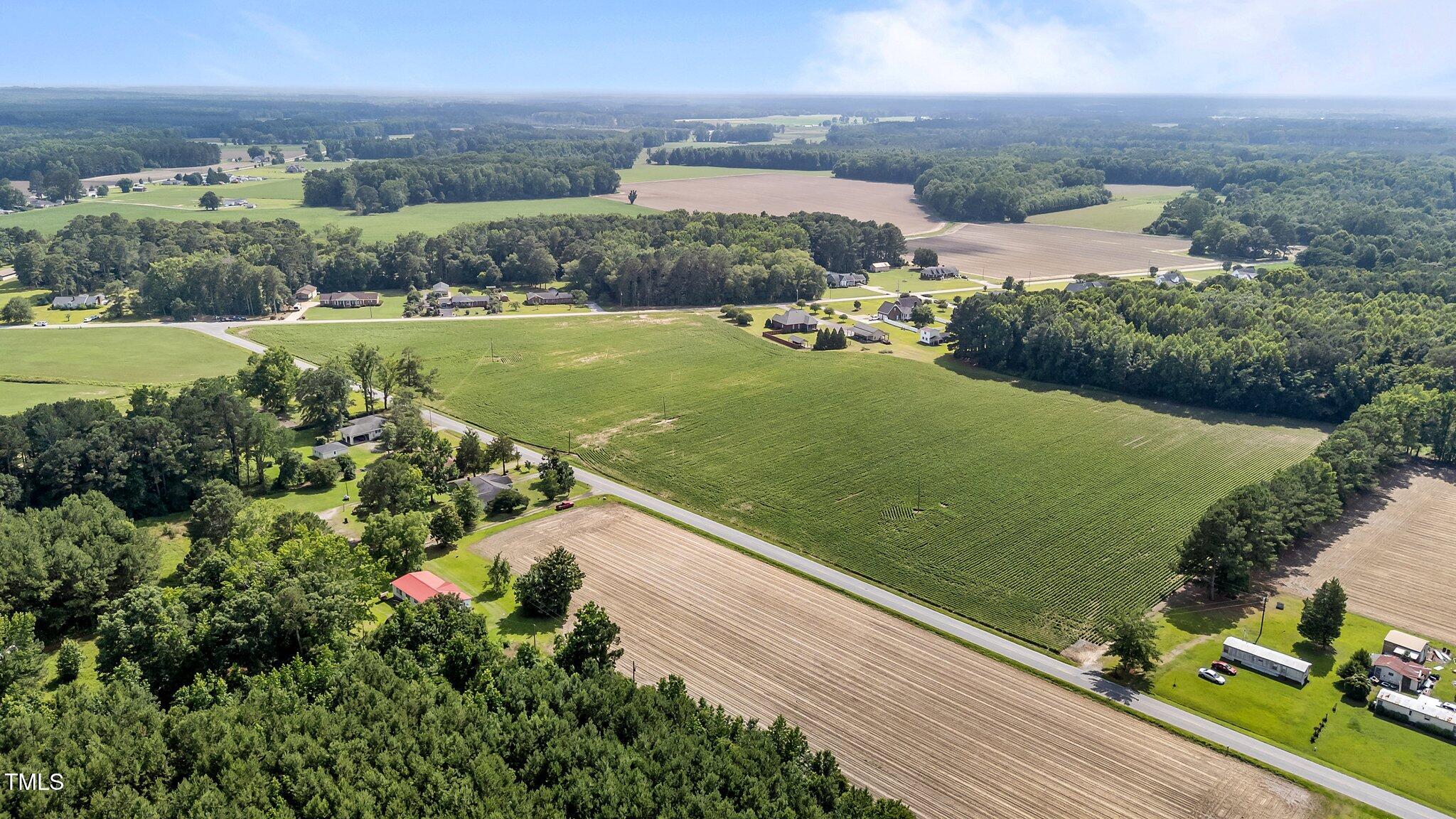 1299 Piney Grove Church Road Kenly, NC 27542 - Photo 1 of 9 an aerial view of a house with a yard