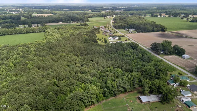 an aerial view of a house with yard lake and green space