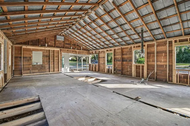 a view of a porch with a table and chairs