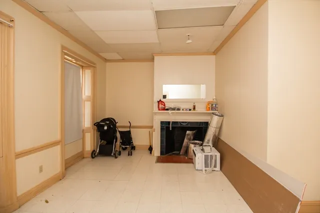 a view of living room with furniture and a fireplace