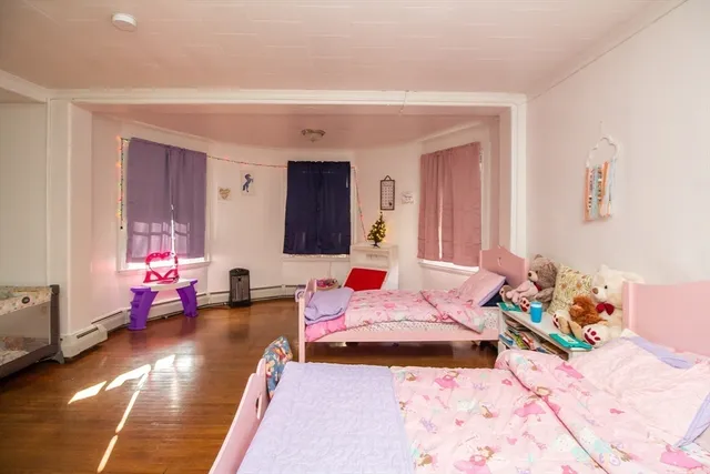 a bedroom with two beds and a couch