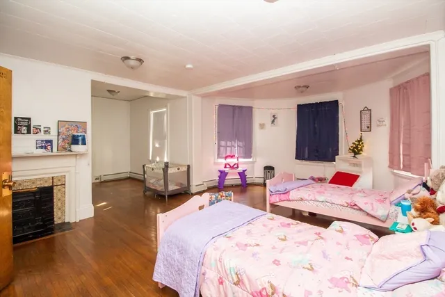 a bedroom with a bed and a fireplace