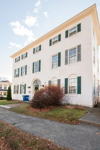 a front view of a building with garden