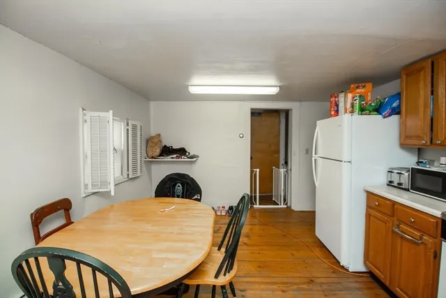 a view of a kitchen with fridge and workspace