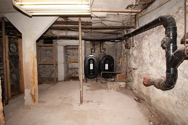 a view of water heater room with a chair