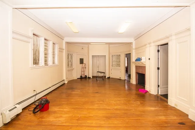 a view of empty room with wooden floor