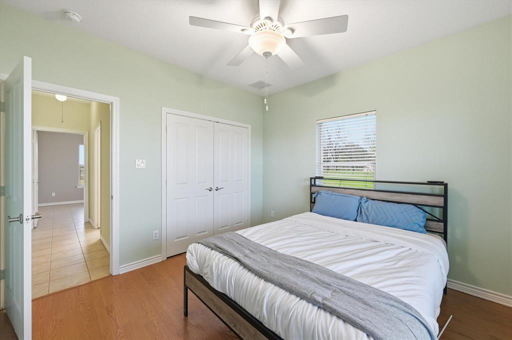 1616 Nash-Howard Road Waxahachie, TX 75165 - Photo 19 of 36 a bedroom with a bed and a chandelier