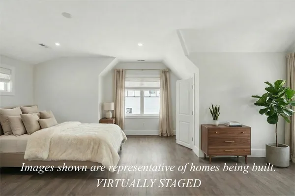 a bedroom with a bed and a potted plant